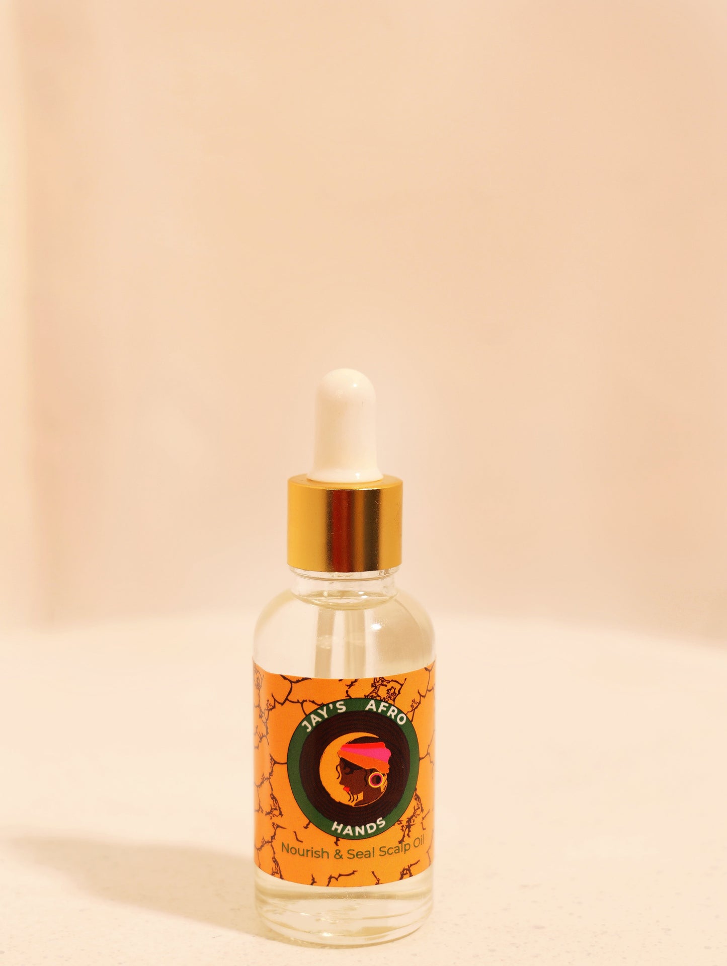 Bottle with dropper labeled 'Jay's Afro Hands' on a beige background