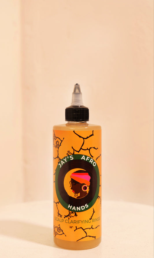 Bottle of 'Jay's Afro Hands' product on a beige background