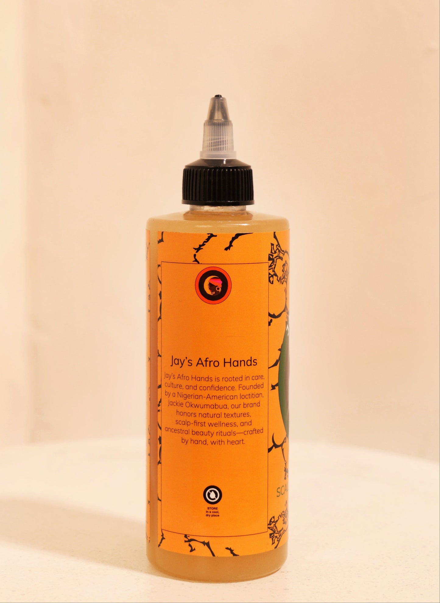 Bottle of 'Jay's Afro Hands' product on a beige background